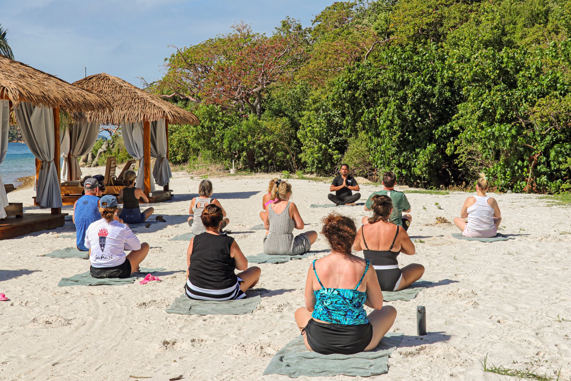 Group of people doing yoga on the beach